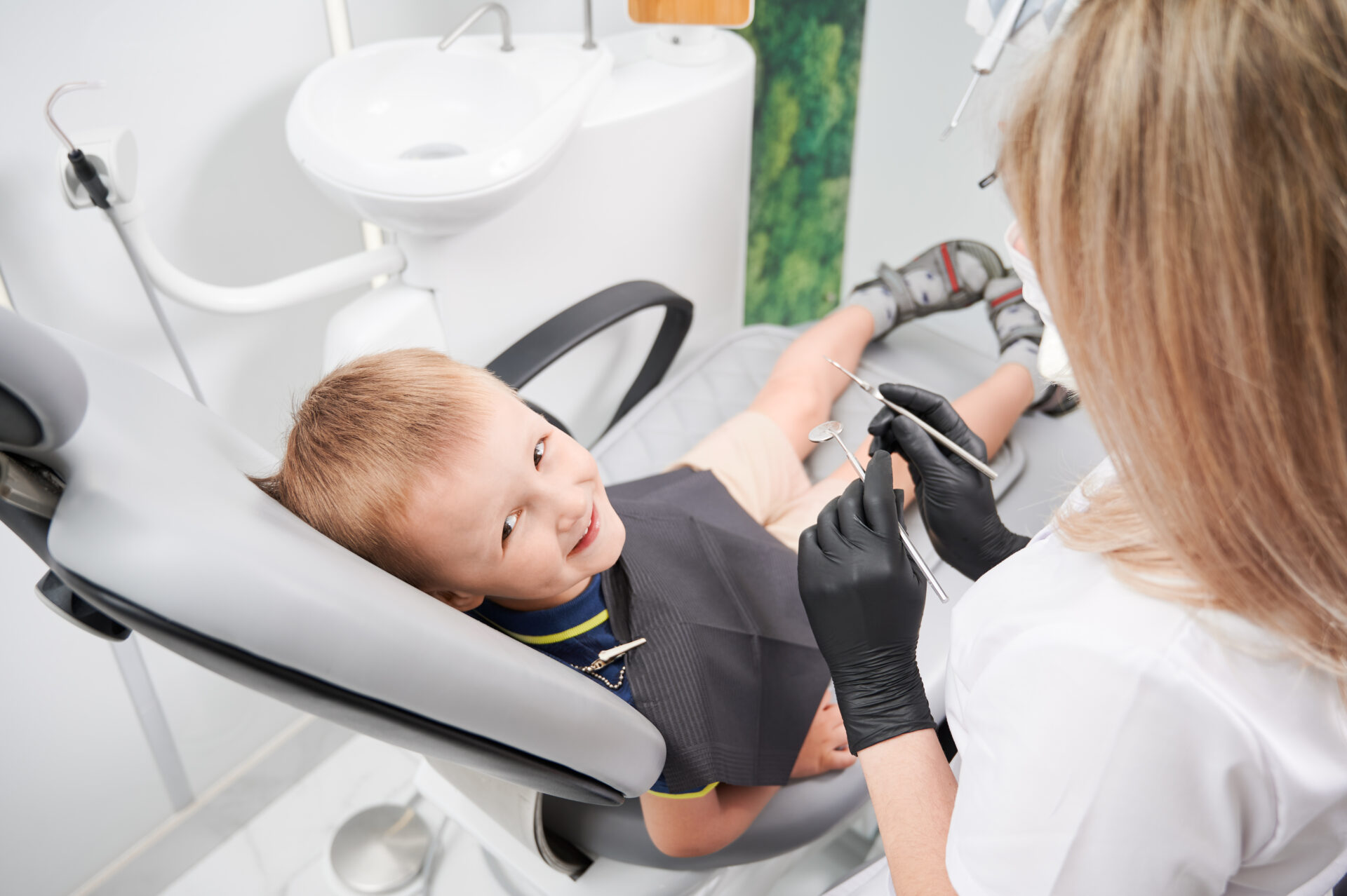 cheerful little boy sitting dental chair dental office